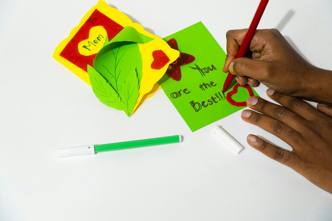 Person writing a handwritten note at a desk